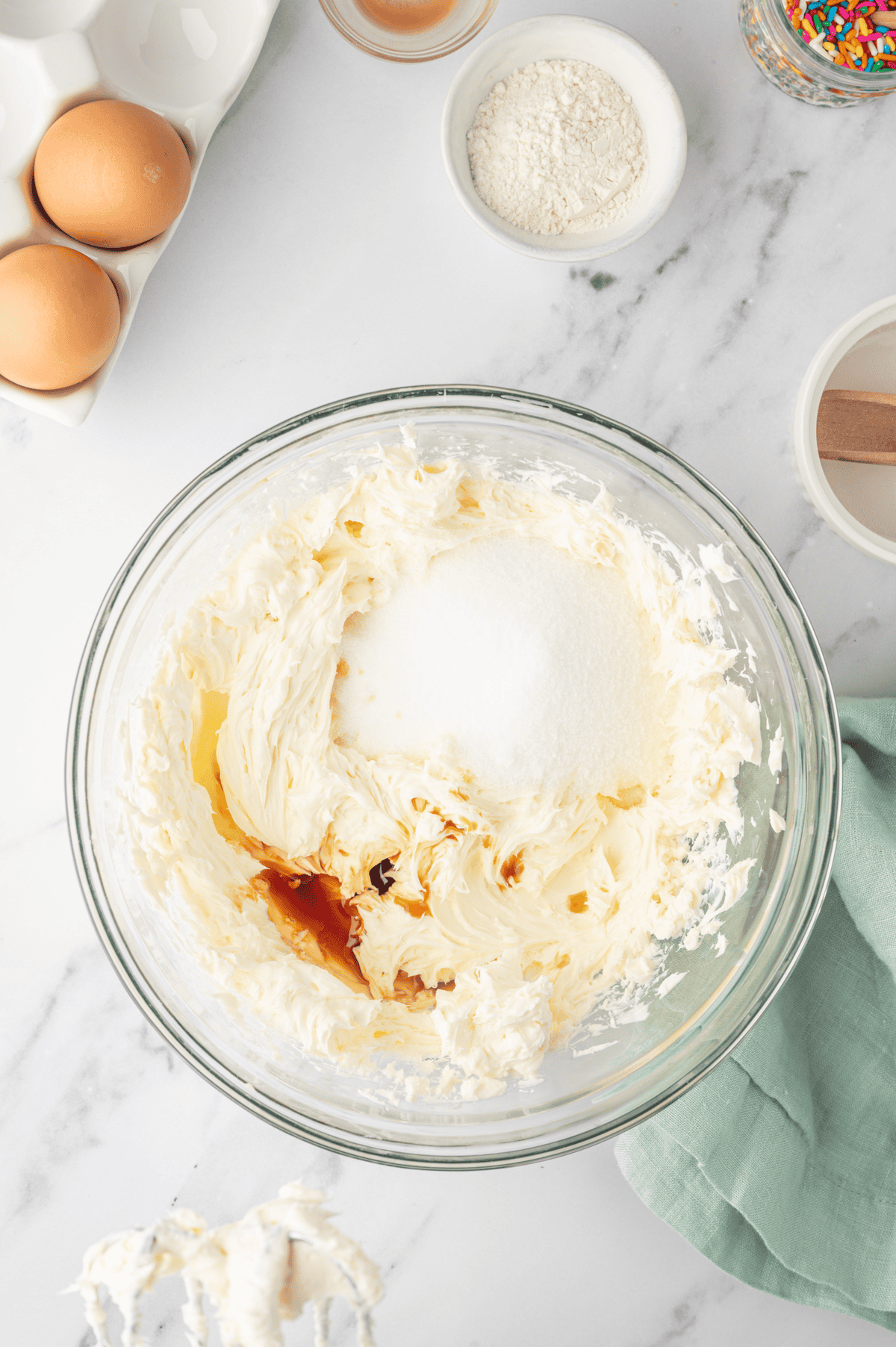 cream cheese and sugar, vanilla, all purpose flour, and heavy cream in bowl 