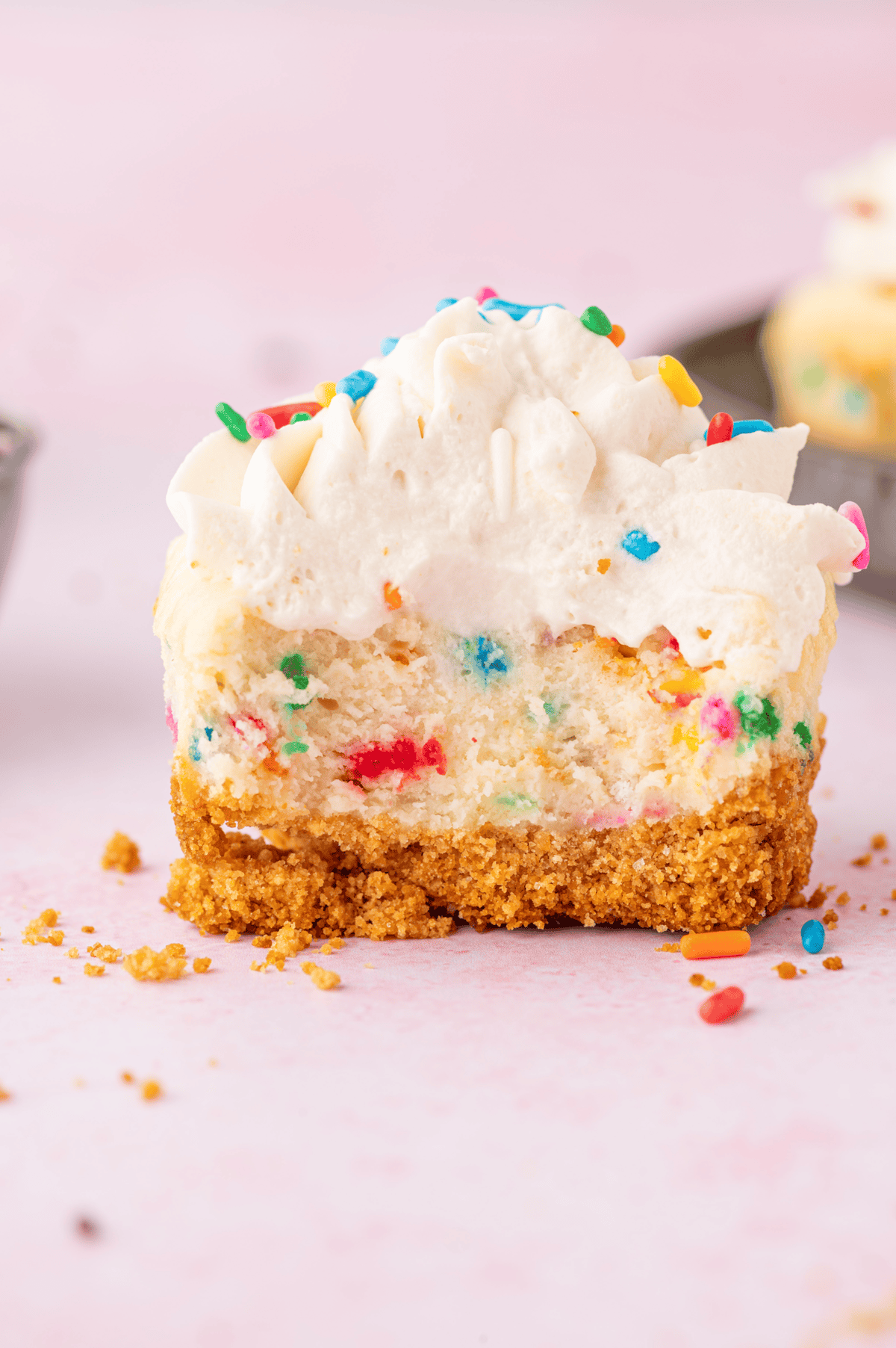 mini funfetti cheesecake with bite taken out of it