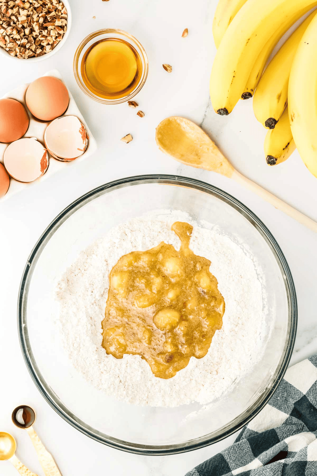 mashed banana mixture in center of dry mixture in bowl