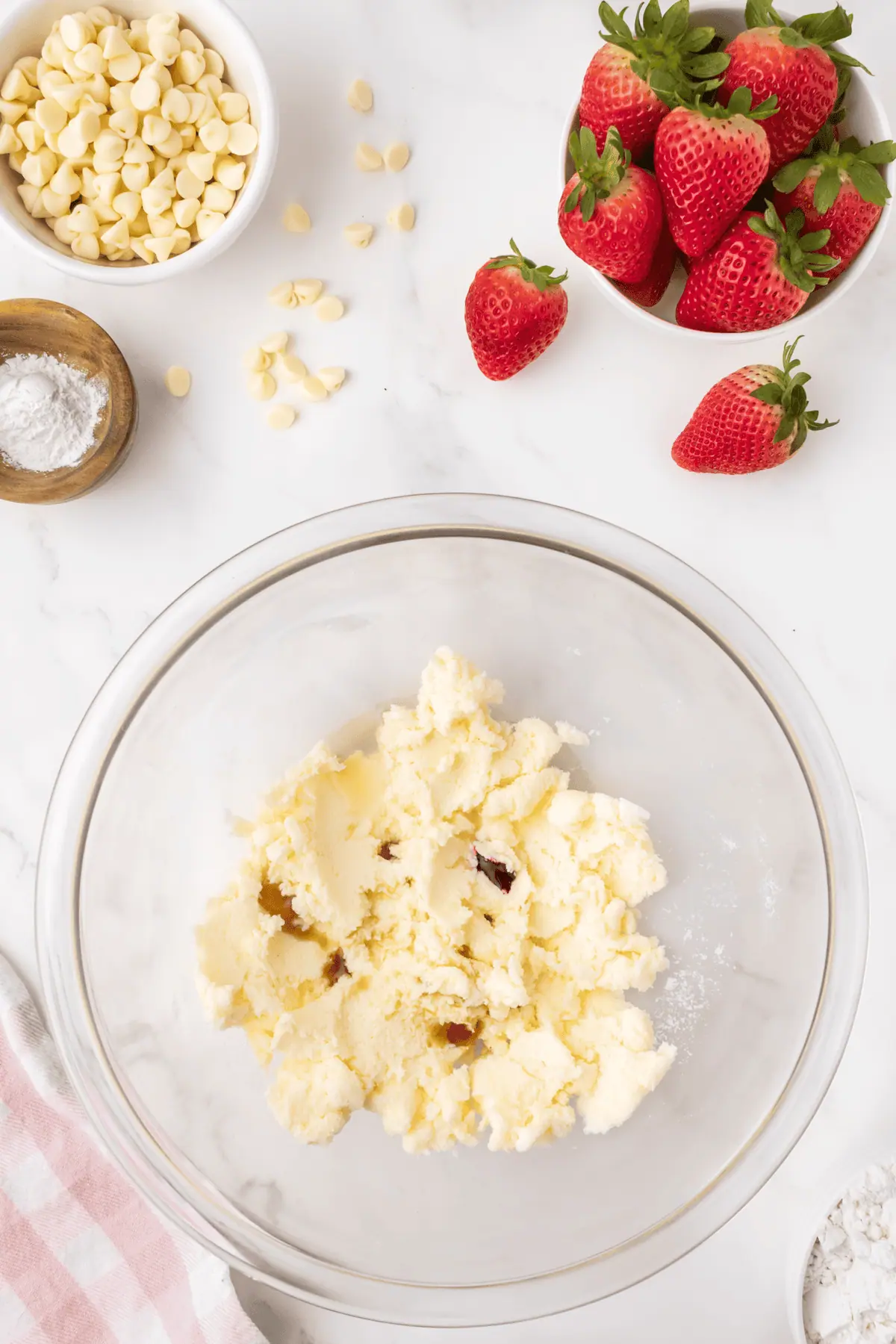 lemon juice, vanilla, and pink food dye added to creamed butter and sugar