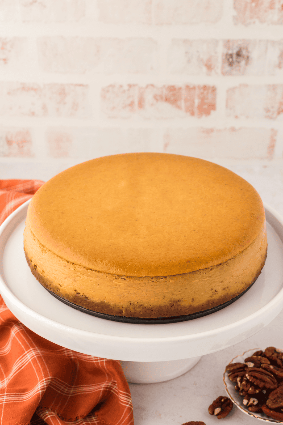 plain baked pumpkin cheesecake on a serving platter