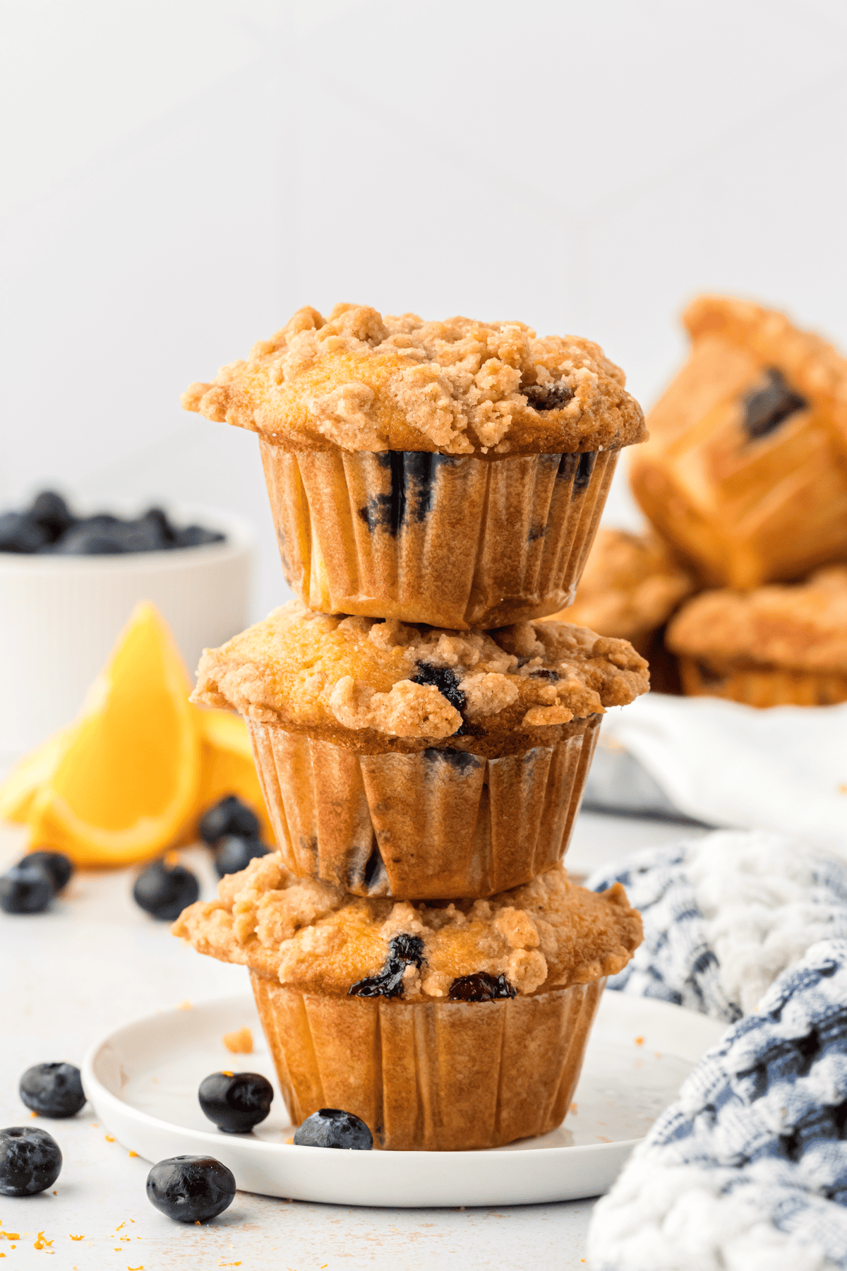three homemade blueberry muffins stacked on top of each other