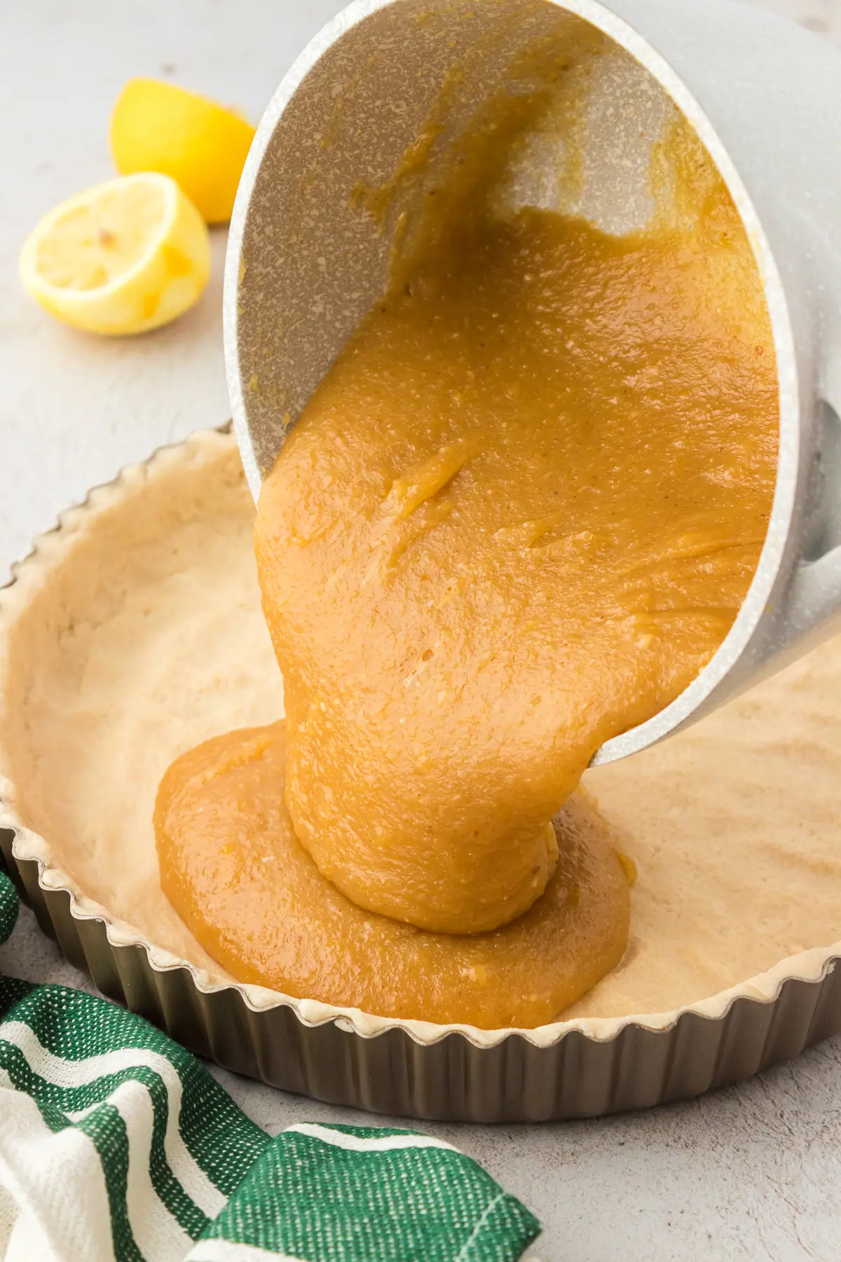 golden syrup filling being poured into tart crust