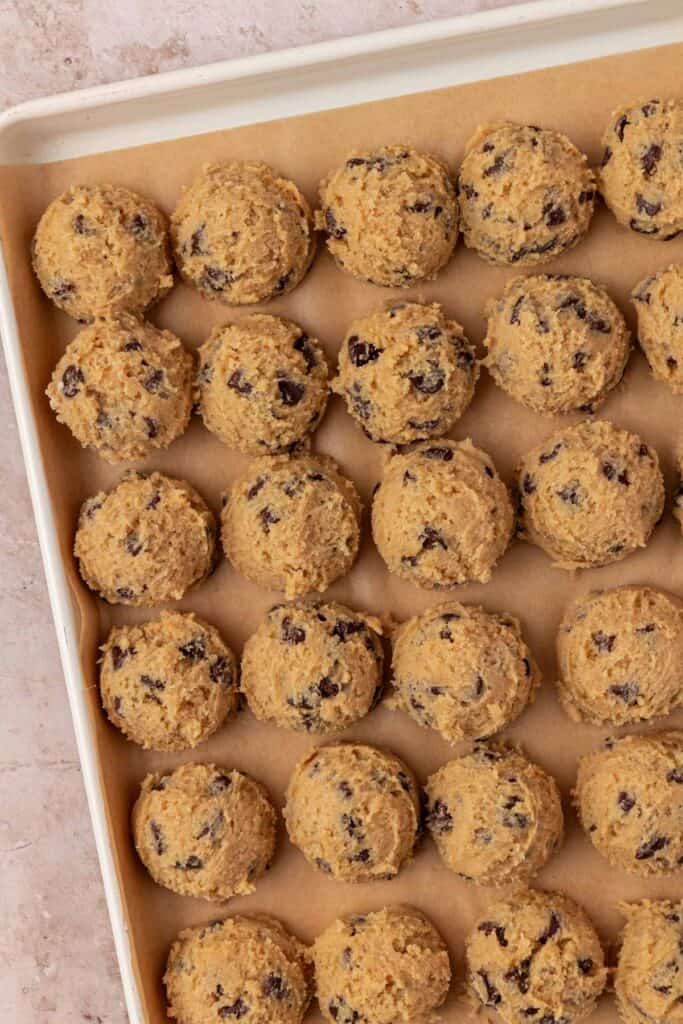 cookie dough balls on a cookie sheet