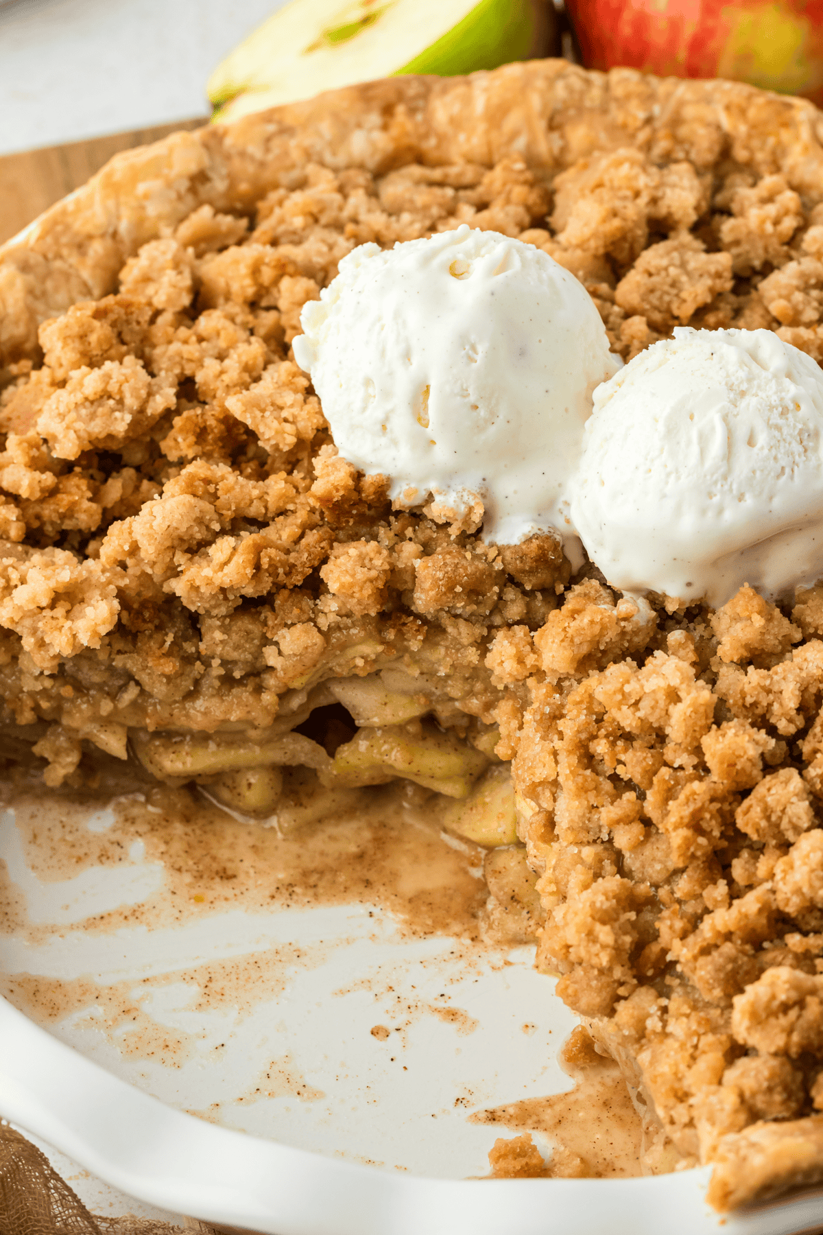 dutch apple pie in a pie pan with a piece missing