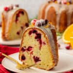 slice of cranberry bundt cake on a plate with a fork