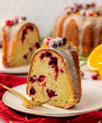 slice of cranberry bundt cake on a plate with a fork