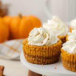mini pumpkin cheesecakes on a cake stand