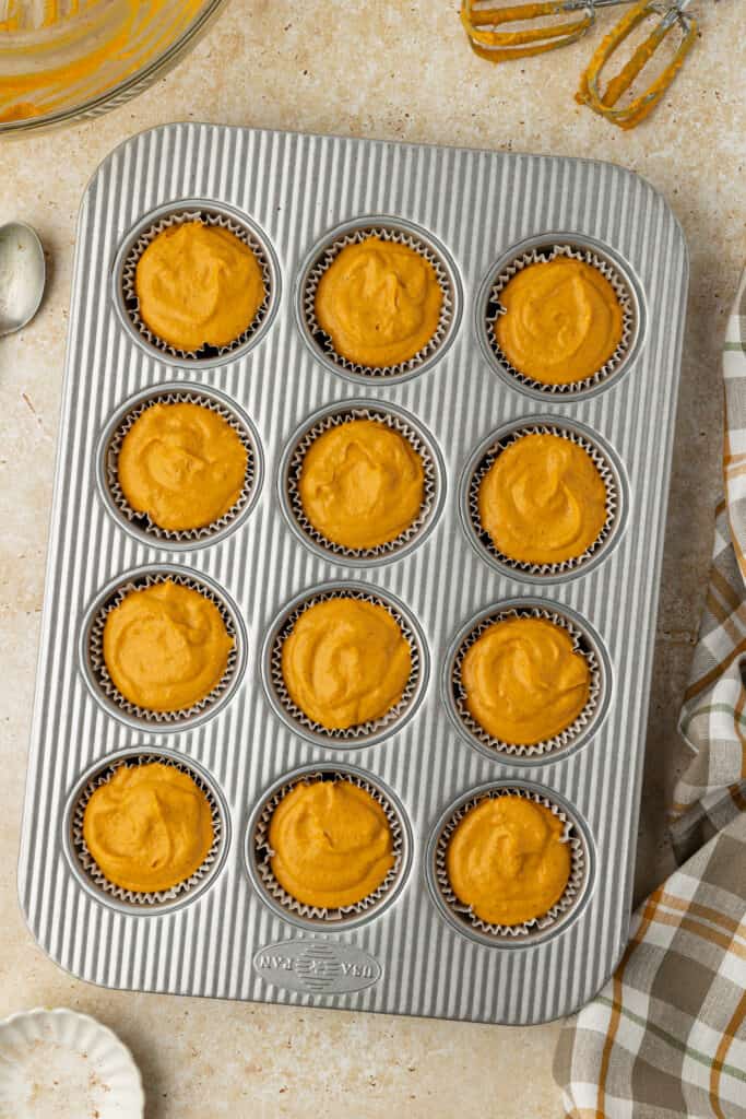 unbaked mini pumpkin cheesecakes in muffin pan