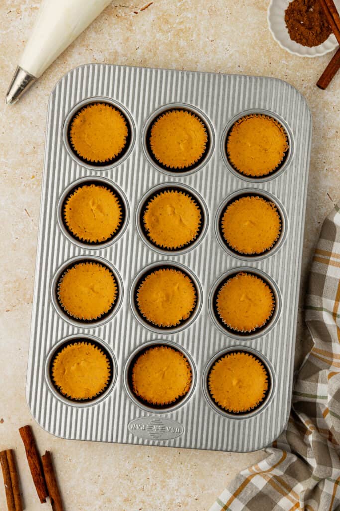 baked mini pumpkin cheesecakes in a muffin tin