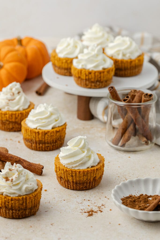 mini pumpkin cheesecakes on a cake stand