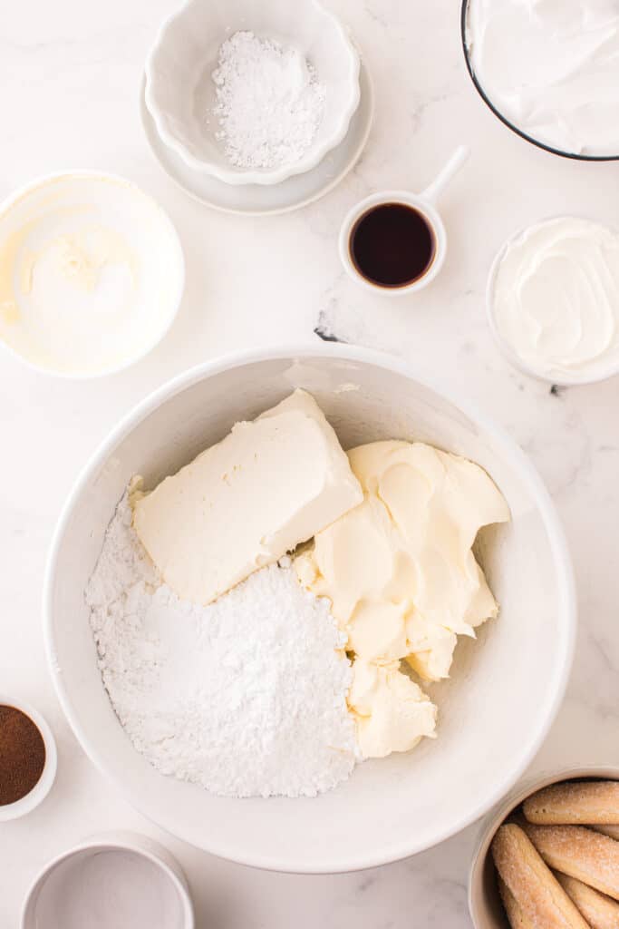 cream cheese, mascarpone, and powdered sugar in a bowl