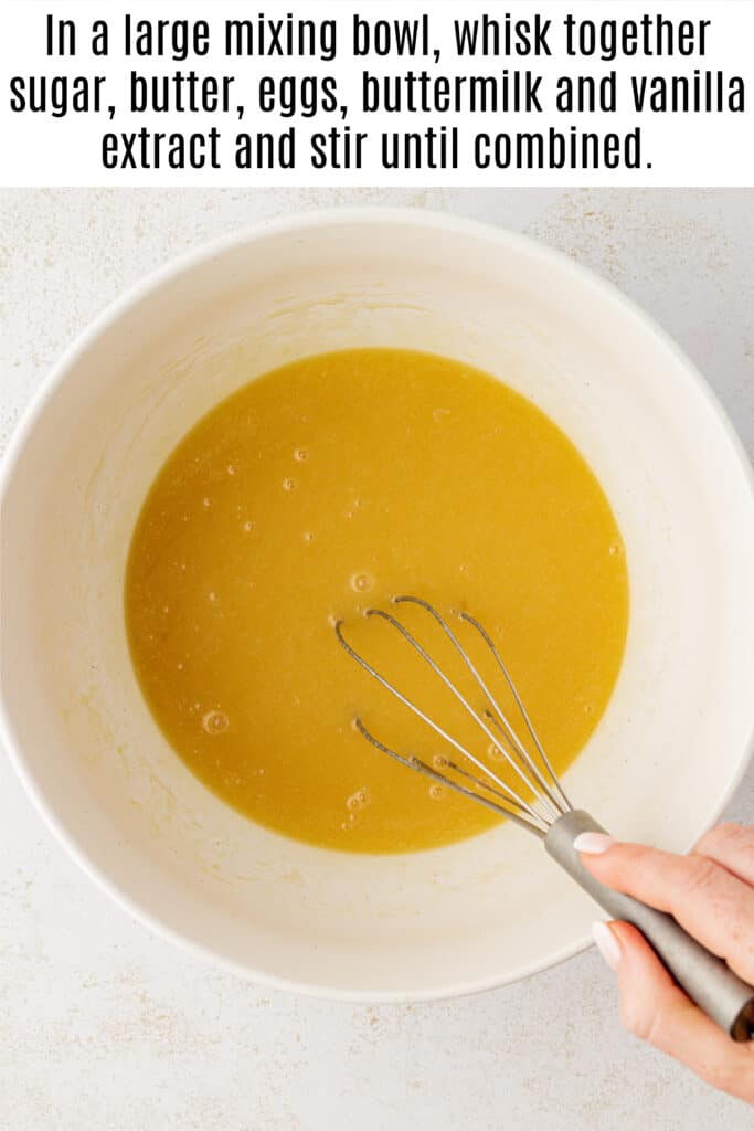 buttermilk banana bread wet ingredients in a bowl with a whisk