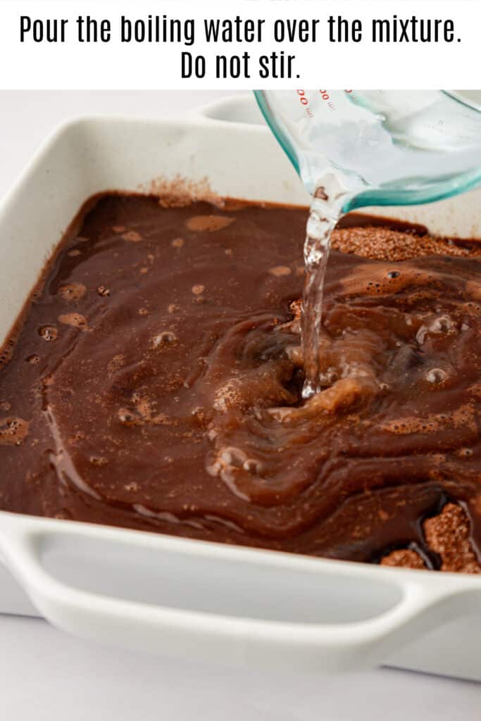 boiling water being poured over chocolate cobbler 