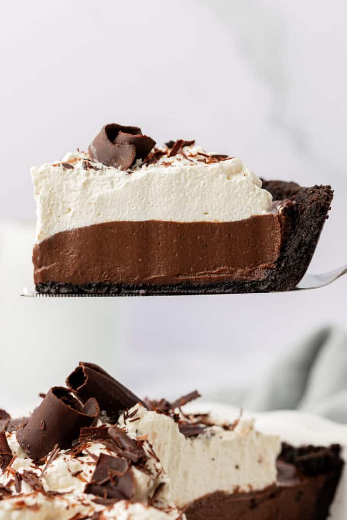 slice of chocolate cream pie with oreo crust being served