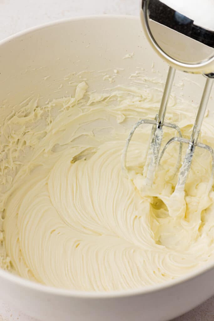 cream cheese and sugar mixed together in a bowl