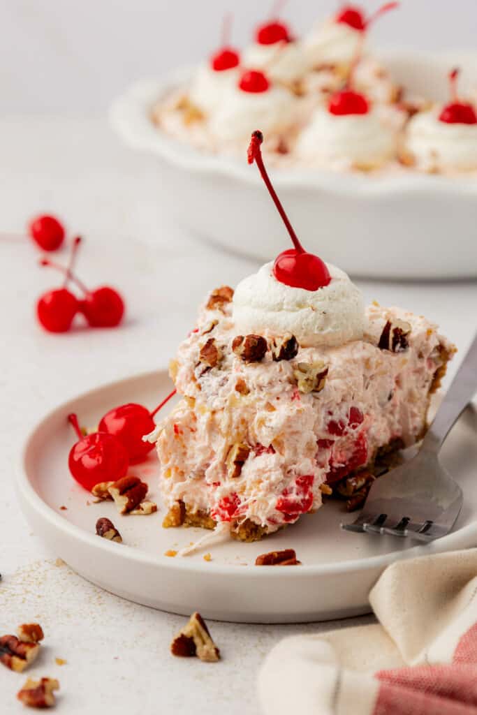 slice of millionaire pie on a plate with a bite missing