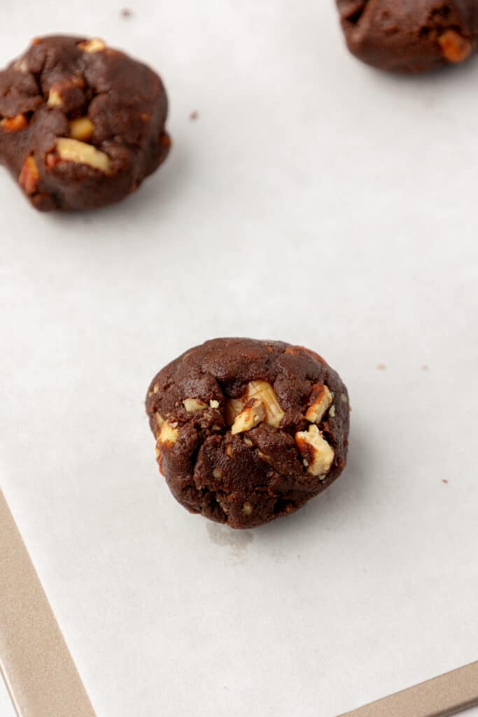 chocolate cookie dough folded up around a caramel