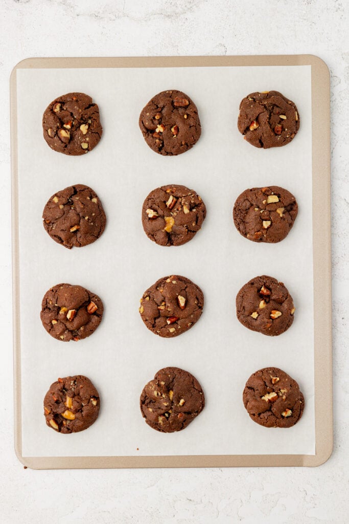 baked chocolate turtle cookies on a cookie sheet