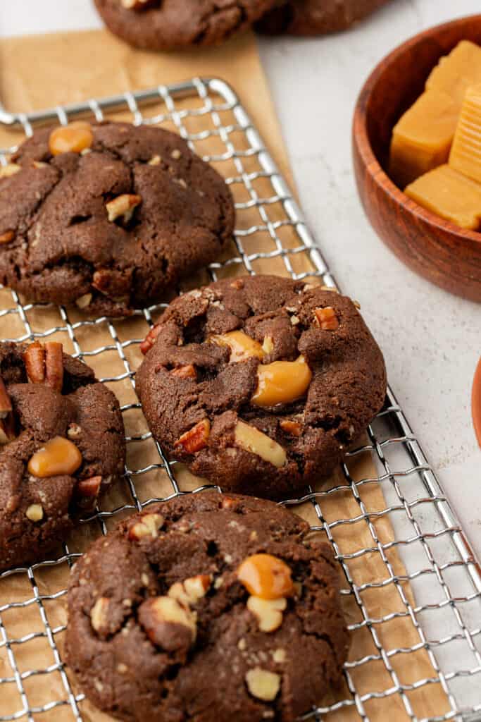 baked chocolate turtle cookies on a wire rack