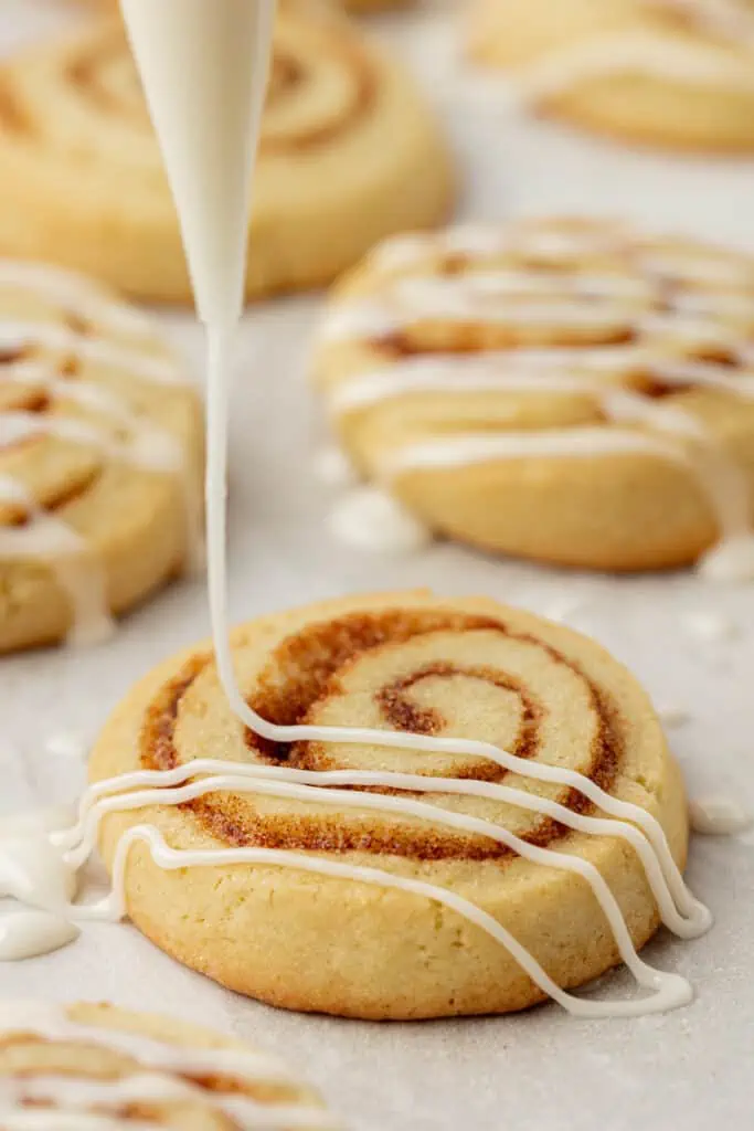 icing drizzled over cinnamon roll cookies
