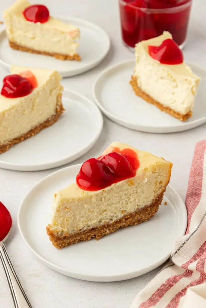 slice of small batch cheesecake on a plate topped with strawberry topping