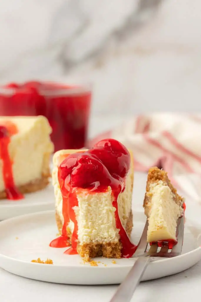 slice of small batch cheesecake on a plate with a fork