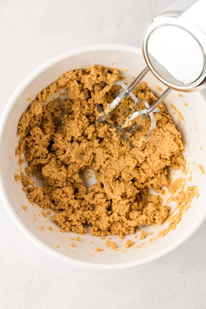 peanut butter filling being mixed with a hand mixer