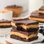 two buckeye brownies stacked on a plate