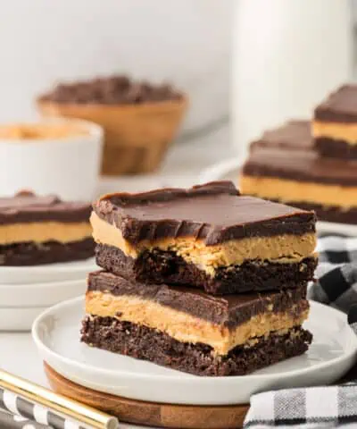 two buckeye brownies stacked on a plate