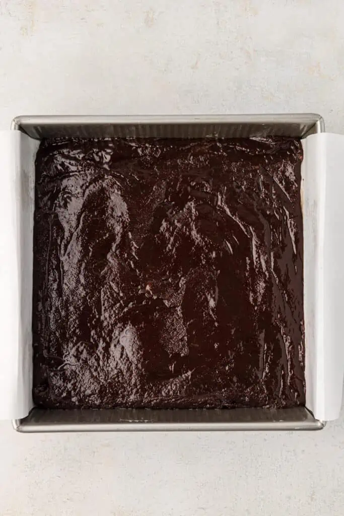 brownie batter spread into baking pan