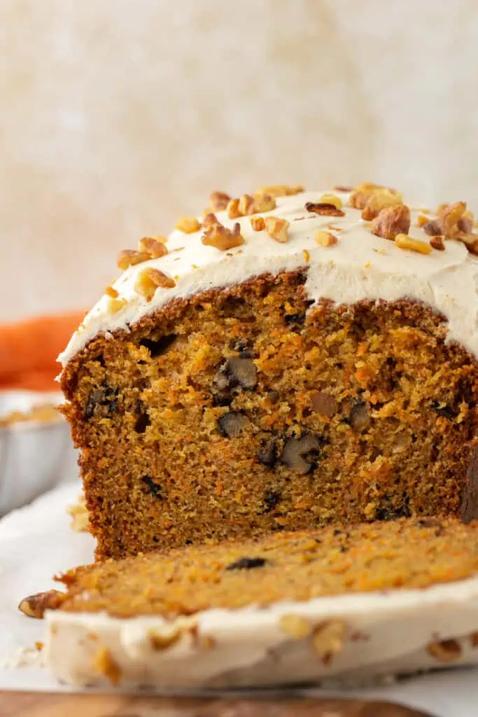 carrot cake loaf topped with cinnamon cream cheese frosting
