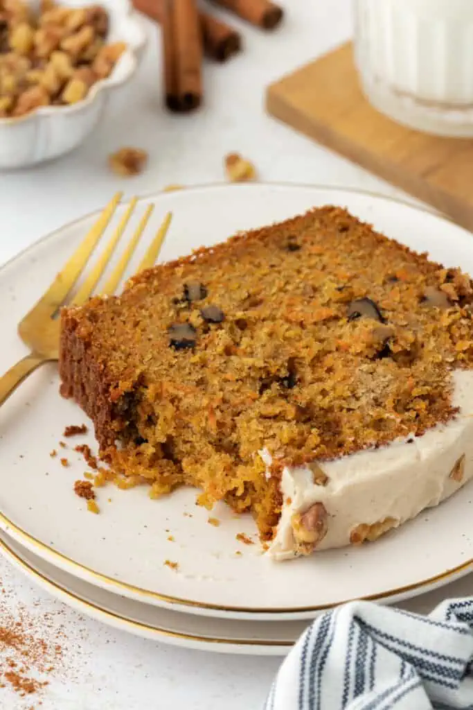slice of carrot cake loaf on a plate with a fork