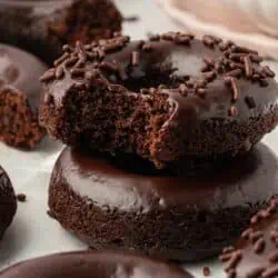 two baked chocolate donuts stacked on top of each other