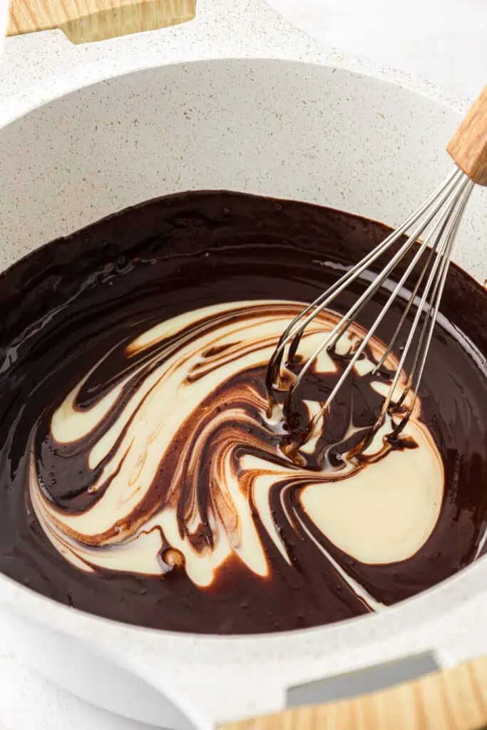 condensed milk stirred into melted chocolate mixture