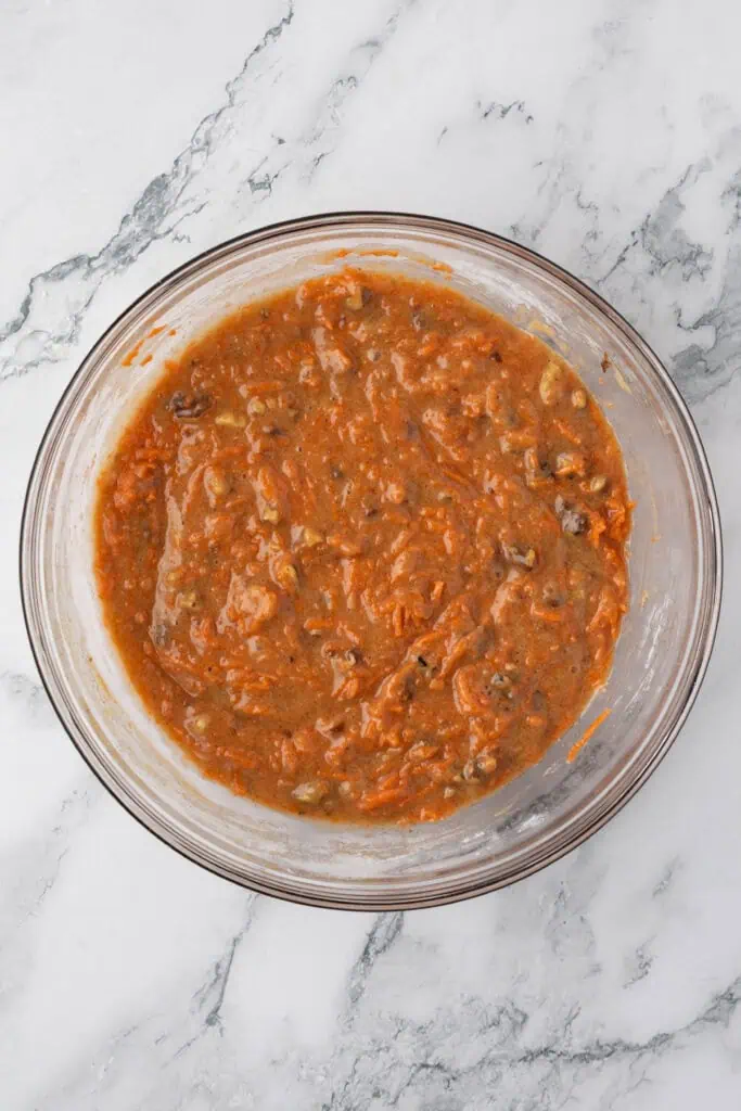carrots and walnuts added to the bowl