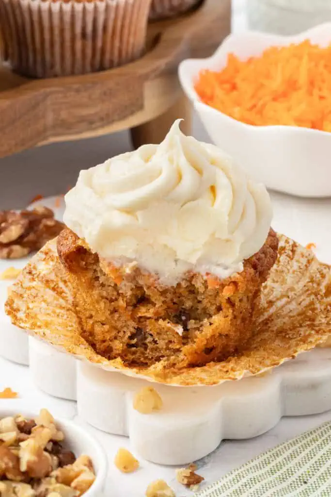 carrot cake cupcake with a bite taken out of it