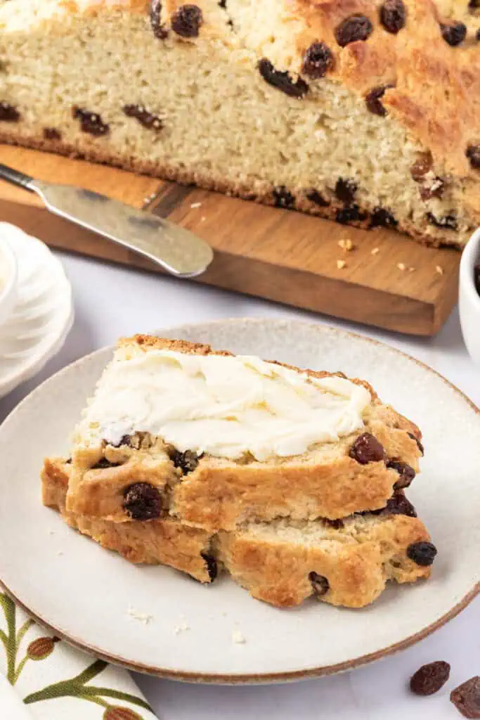 two slices of irish soda bread on a plate topped with butter