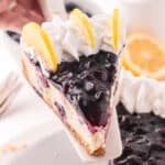 spatula serving a slice of lemon blueberry cheesecake