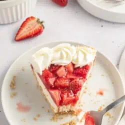 slice of strawberry cream cheese pie on a plate with a fork