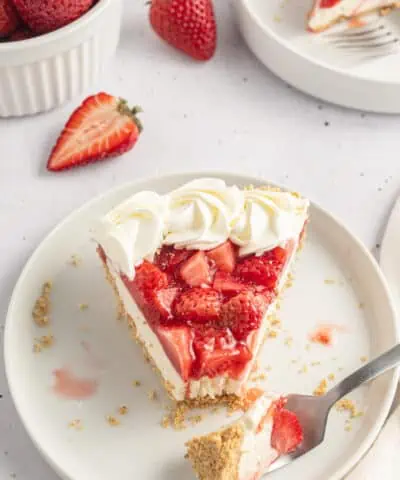 slice of strawberry cream cheese pie on a plate with a fork