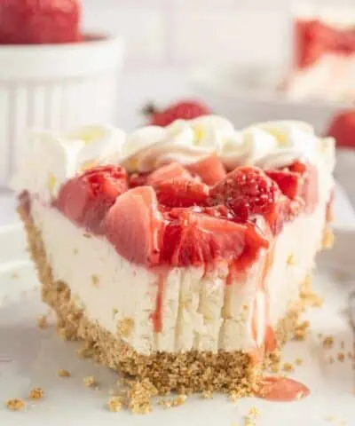 slice of strawberry cream cheese pie on a plate with a bite missing