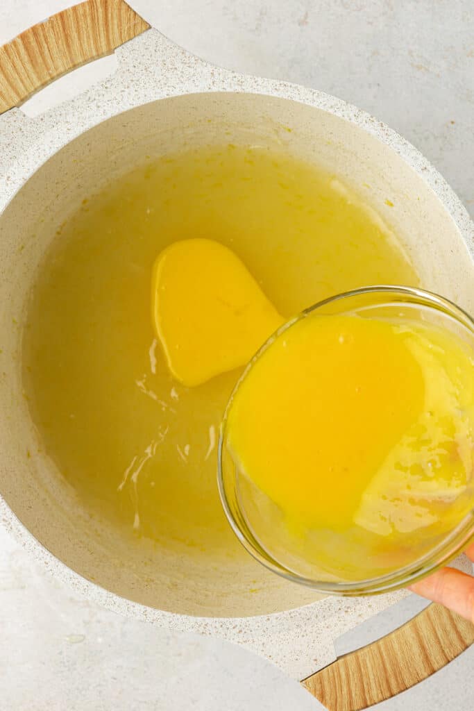 egg yolks being tempered for lemon curd