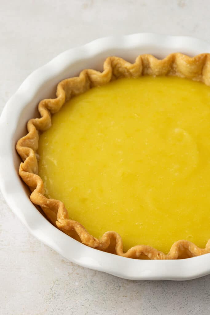 lemon curd spread into pie crust