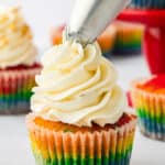 marshmallow buttercream piped onto a rainbow cupcake