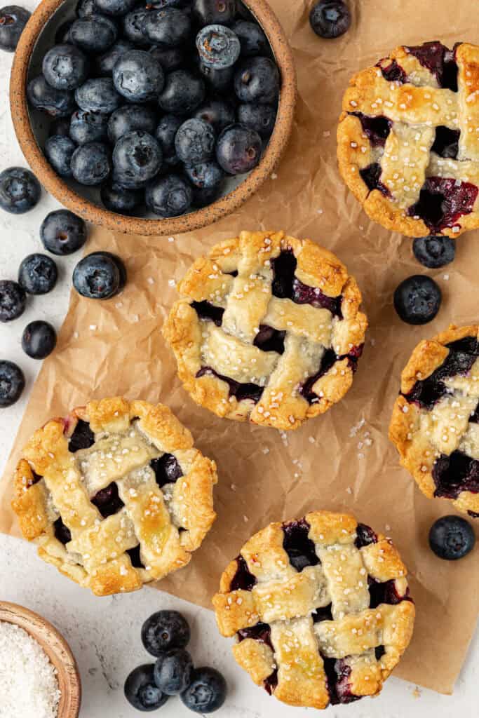 mini blueberry pies on parchment paper