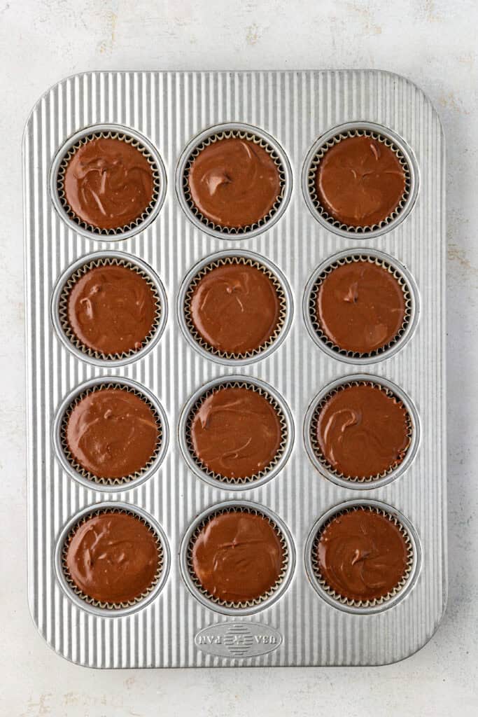 unbaked mini chocolate cheesecakes in a muffin tin