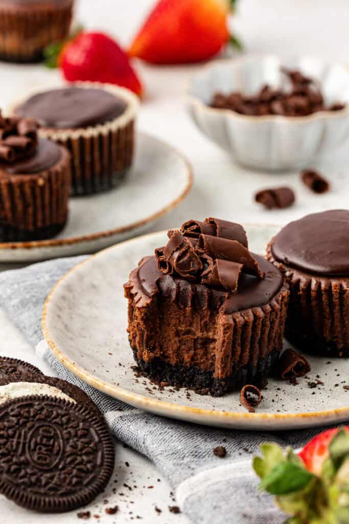 mini chocolate cheesecake on a plate with a forkful missing
