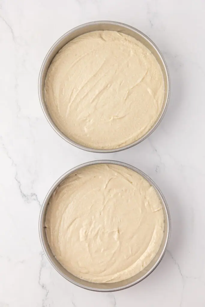 two cake pans filled with cake batter