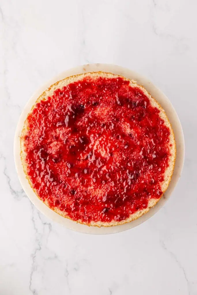 raspberry jam mixture spread onto a cake layer